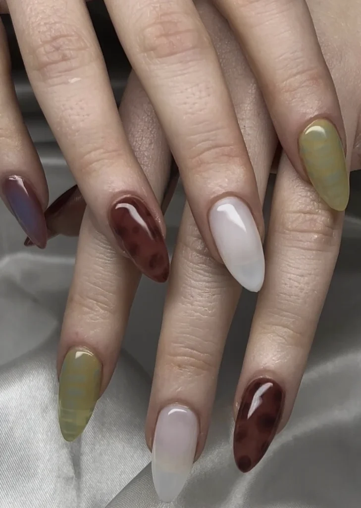 Almond Nails with Earth Tone Swirls and Milky White Accents