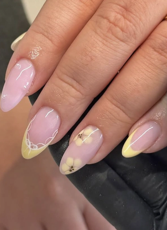 Almond Nails with Yellow Tips, Lace Detail, and Flower Accents