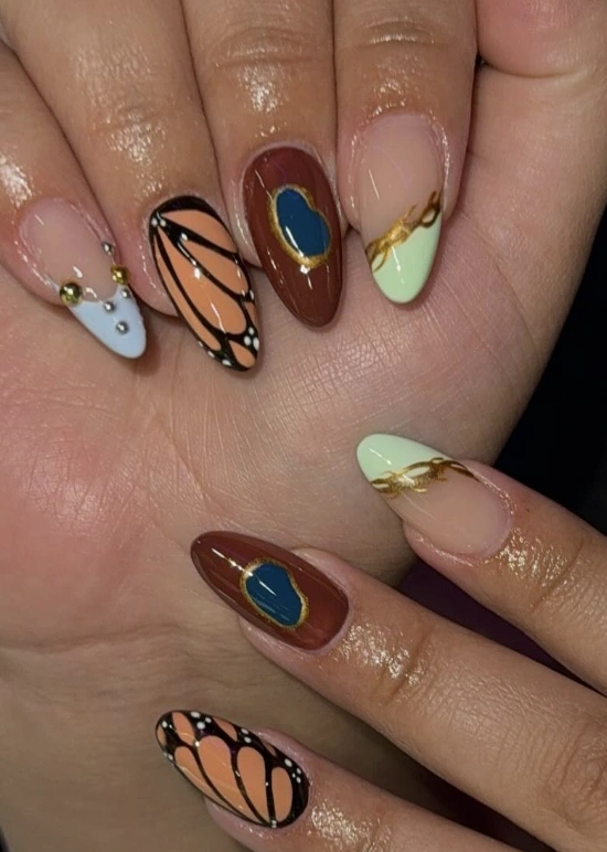 Assorted Almond Nails: Monarch Wing, Beaded Sky, and Golden Lace
