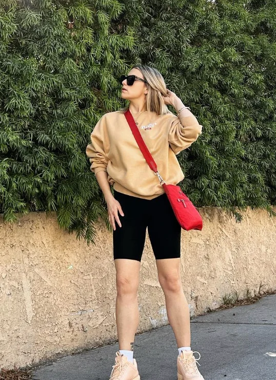 Beige Sweatshirt + Black Bike Shorts + Red Crossbody Bag