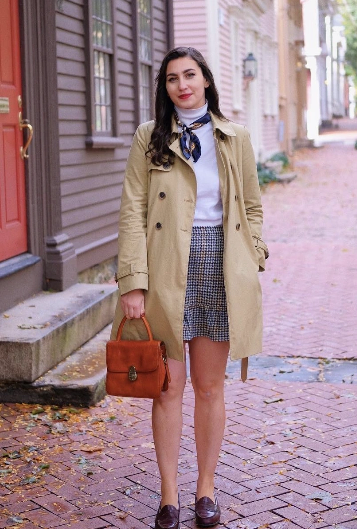 Beige Trench Coat + White Turtleneck Sweater + Houndstooth Mini Skirt + Navy Printed Scarf + Brown Leather Satchel + Burgundy Loafers