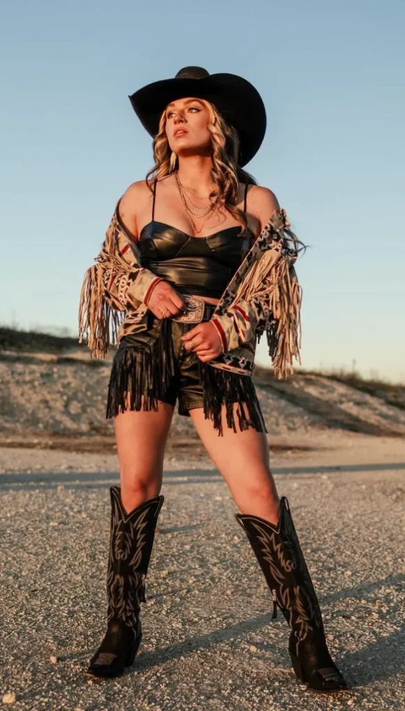 Black Cowboy Hat + Black Leather Fringe Jacket + Black Leather Bustier Top + Black Fringe Shorts + Black Western Boots