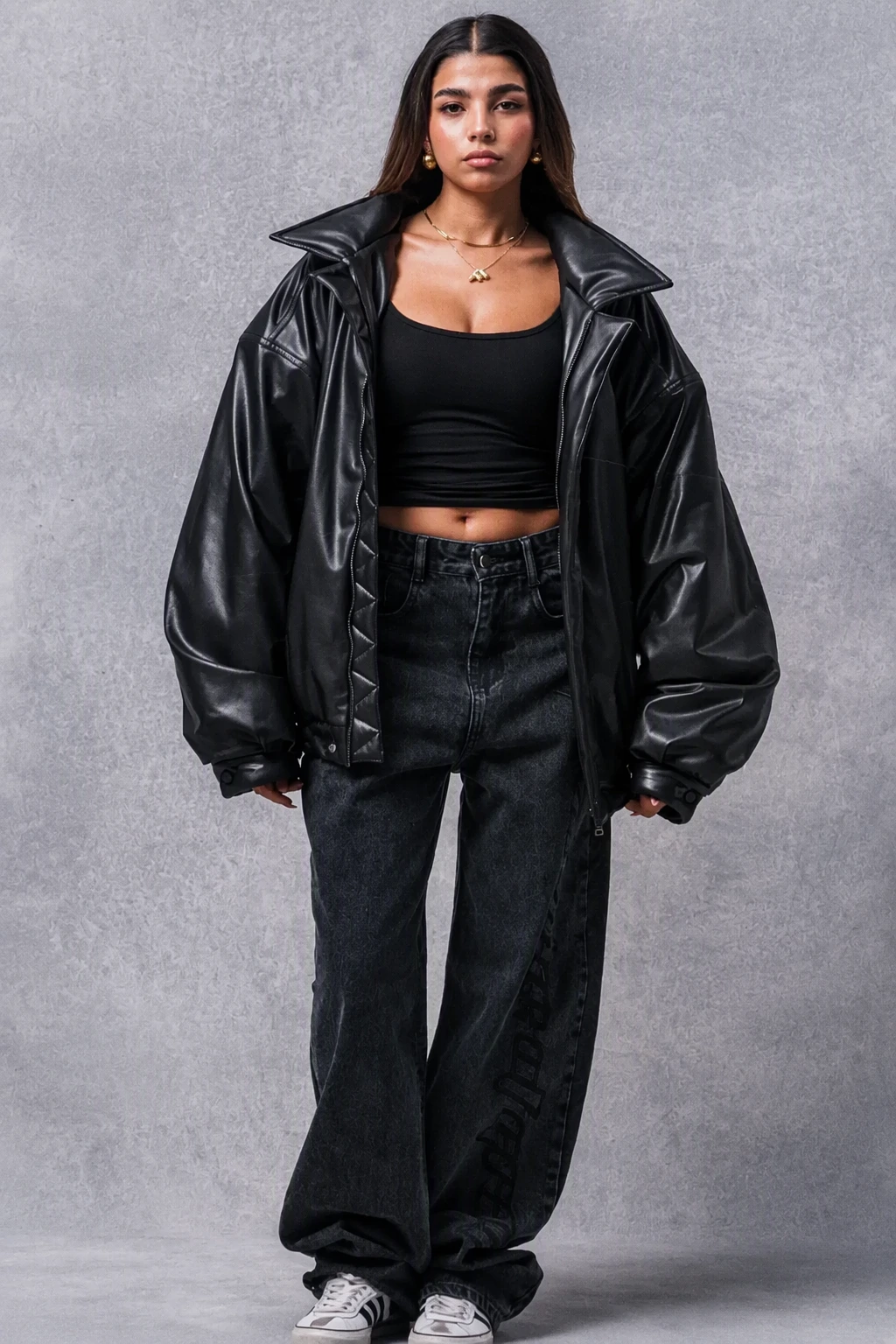Black Leather Oversized Jacket + Black Fitted Crop Top + Dark Wash Wide-Leg Jeans + White Sneakers + Gold Pendant Necklace