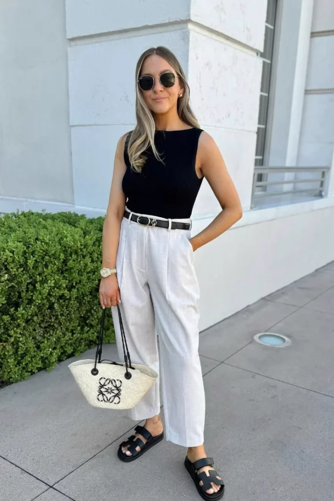 Black Sleeveless Tank Top + White Wide-Leg Trousers + Black Belt + Black Slide Sandals