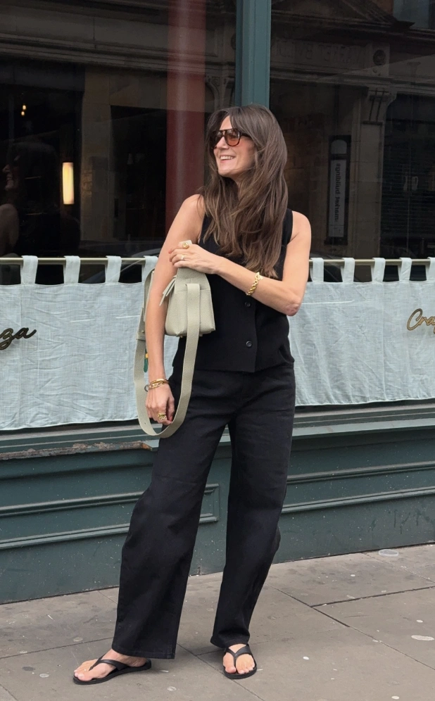 Black Sleeveless Vest + Black Wide-Leg Trousers + Black Flat Sandals + Gold Bracelet