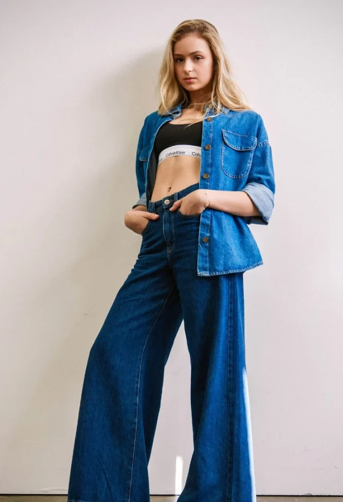 Blue Denim Cropped Jacket + White Branded Sports Bra + Dark Blue Wide-Leg Jeans