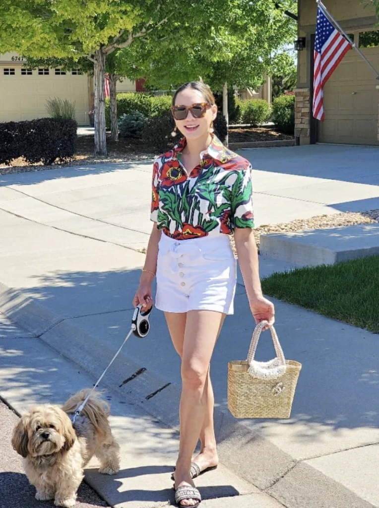 Bold Floral Button-Up Shirt + White High-Waisted Shorts + Black Slide Sandals