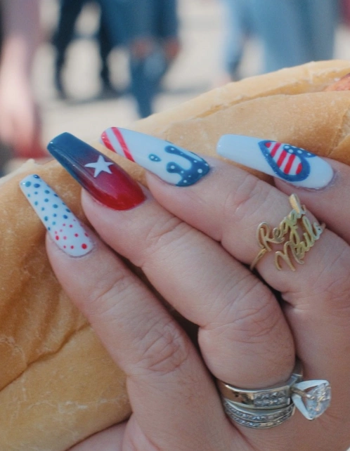 Bold Red, White, and Blue Stiletto Nails with Star and Stripe Designs