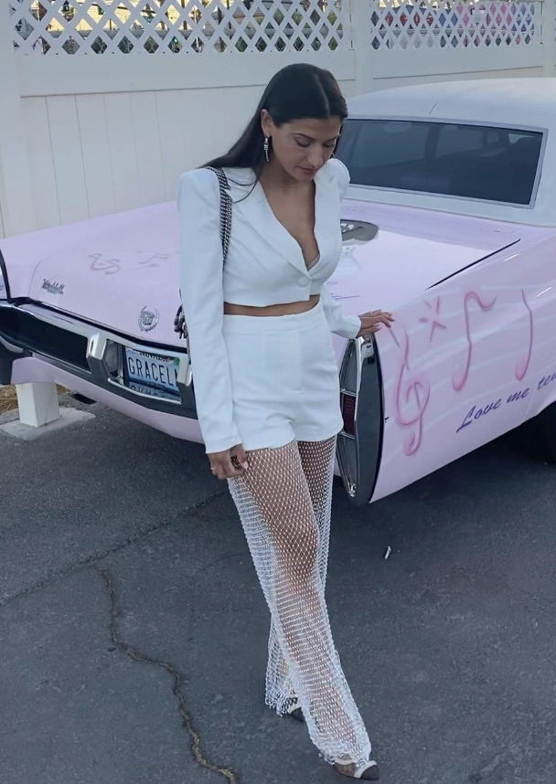 Bold White Blazer + Chic White Crop Top + Stylish White Shorts + Eye-Catching Fishnet Pants + Elegant Heels
