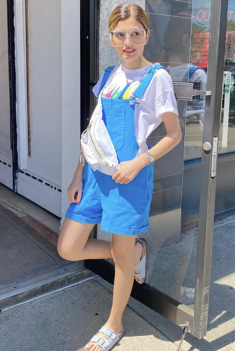 Bright Blue Overall Shorts + Colorful Graphic Tee + Stylish White Fanny Pack + Comfortable Slide Sandals