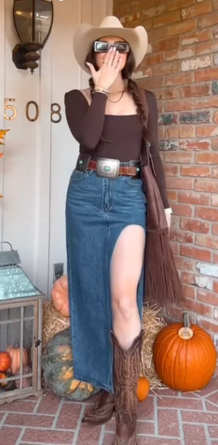 Brown Long-Sleeve Crop Top + Blue High-Slit Denim Maxi Skirt + Brown Western Cowboy Boots + Beige Cowboy Hat + Brown Fringe Cardigan