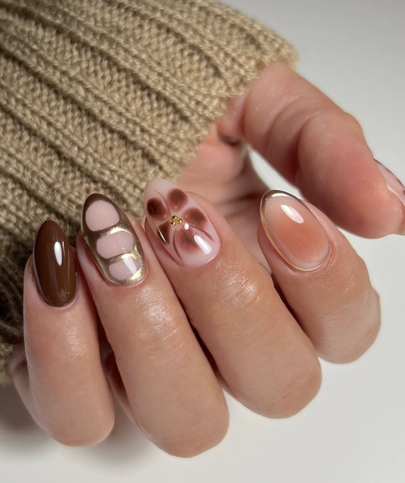 Chic Brown and Nude Gel Nail Design with Geometric Patterns and Gold Detailing