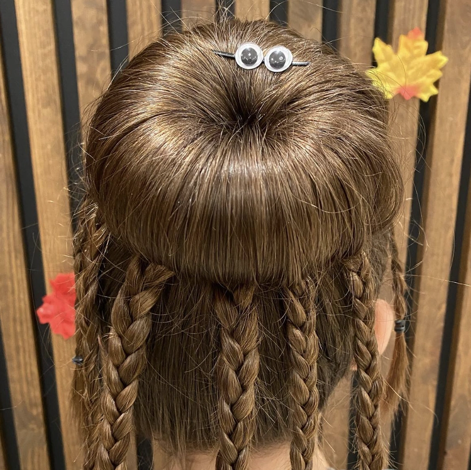 Chic High Bun with Intricate Braids and Playful Googly Eyes