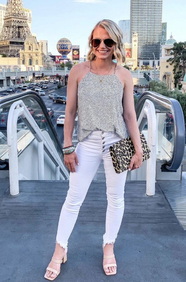 Chic Polka Dot Halter Top + White Frayed Hem Jeans + Beige Block Heeled Sandals + Leopard Print Clutch Bag