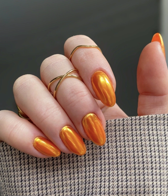 Chrome Orange Almond Nails with Minimalist Gold Rings
