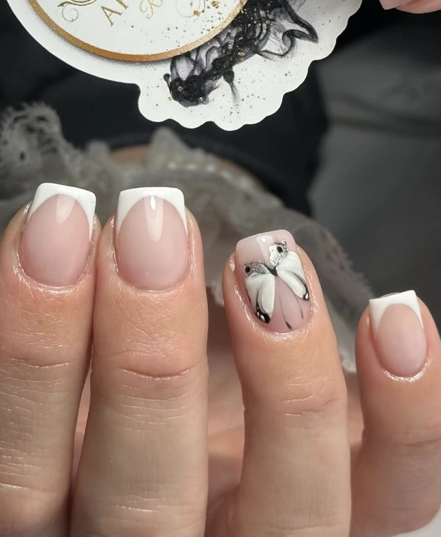 Classic French Manicure with a Butterfly Accent Nail