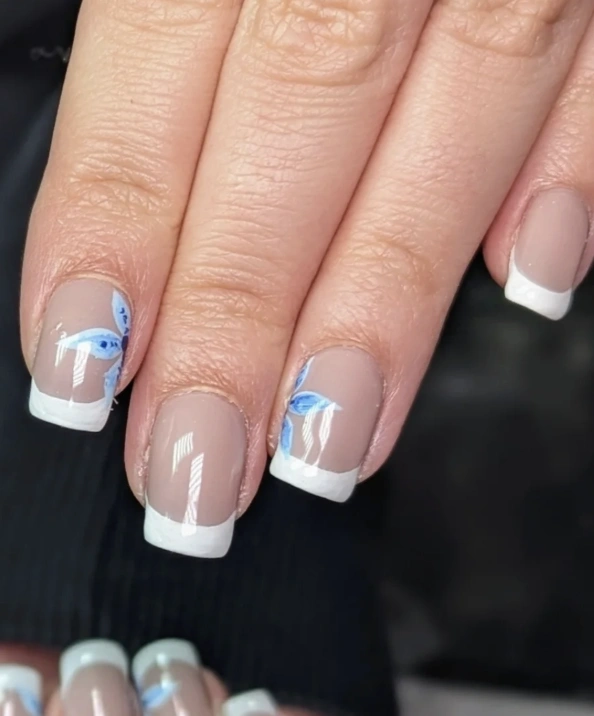Classic French Manicure with Delicate Blue Butterfly Accents