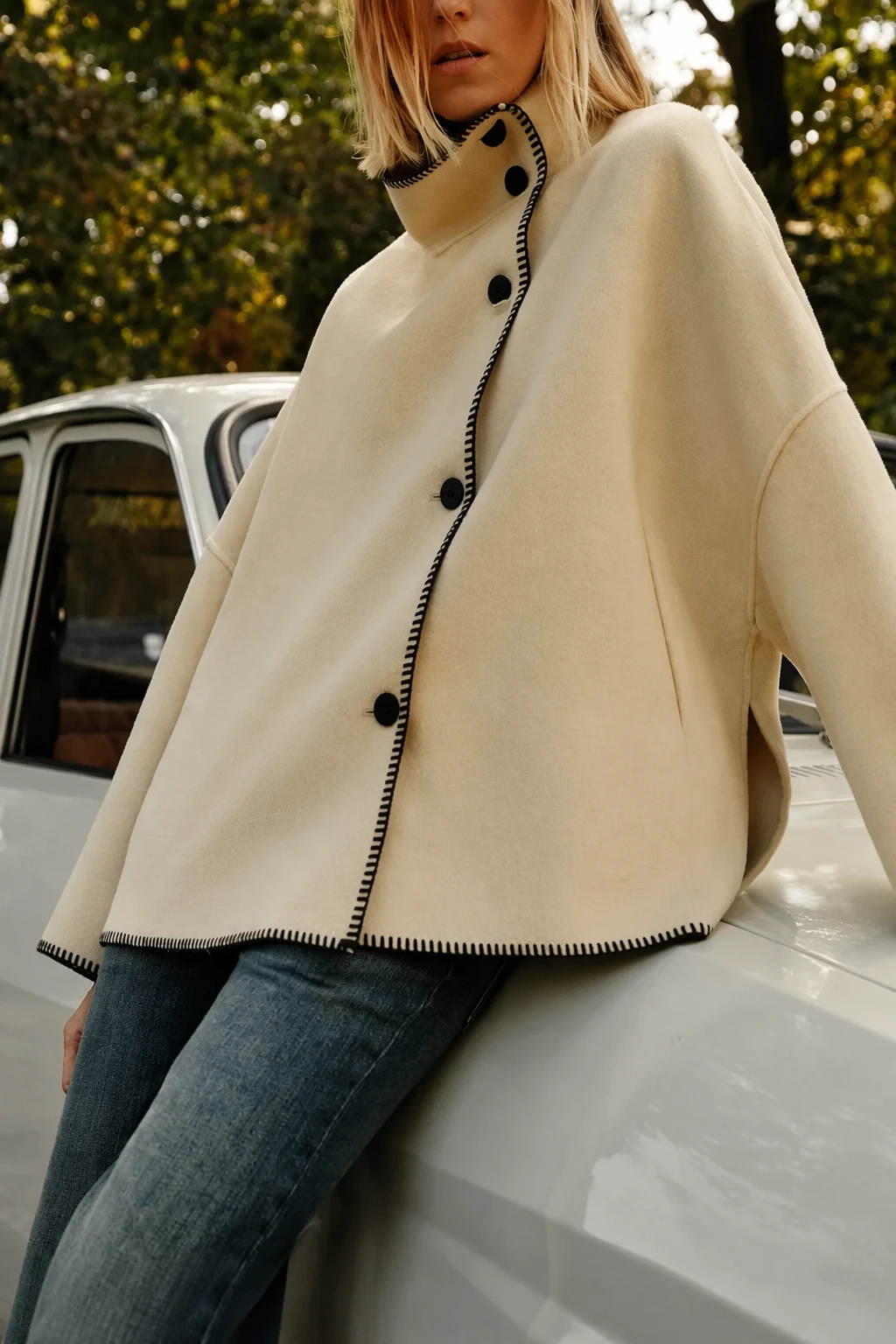 Cream High Collar Coat + Washed Denim Jeans