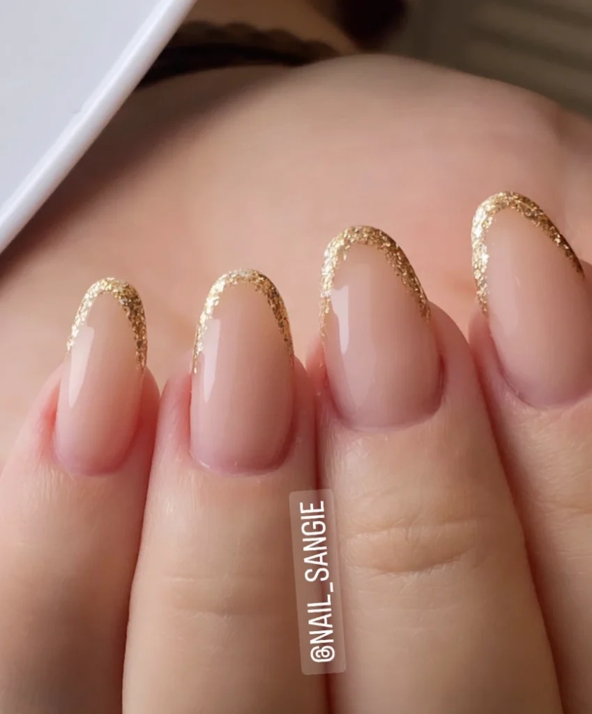 Delicate Almond Nude Nails with Gold Glitter Tips