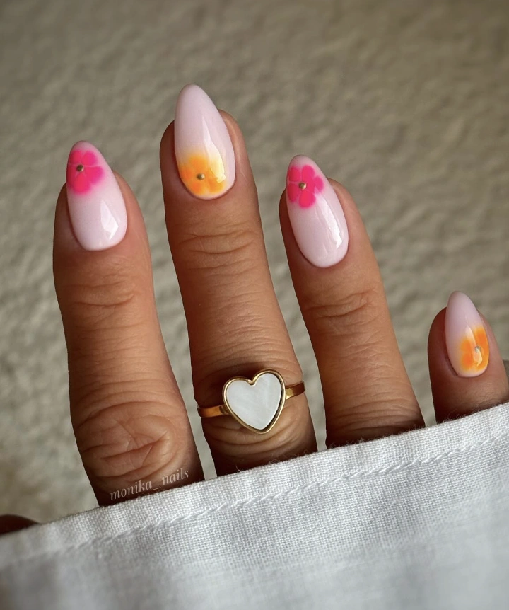 Delicate Almond-Shaped Milky White Nails with Floral Accents and Subtle Ombre