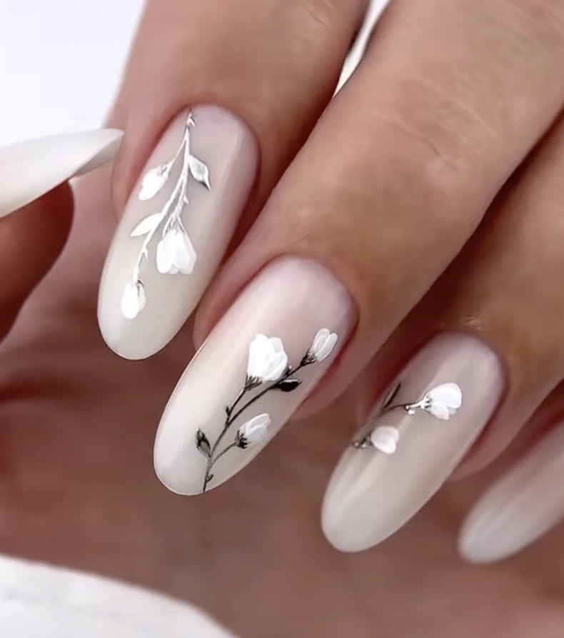 Delicate Almond-Shaped Milky White Nails with Floral Accents