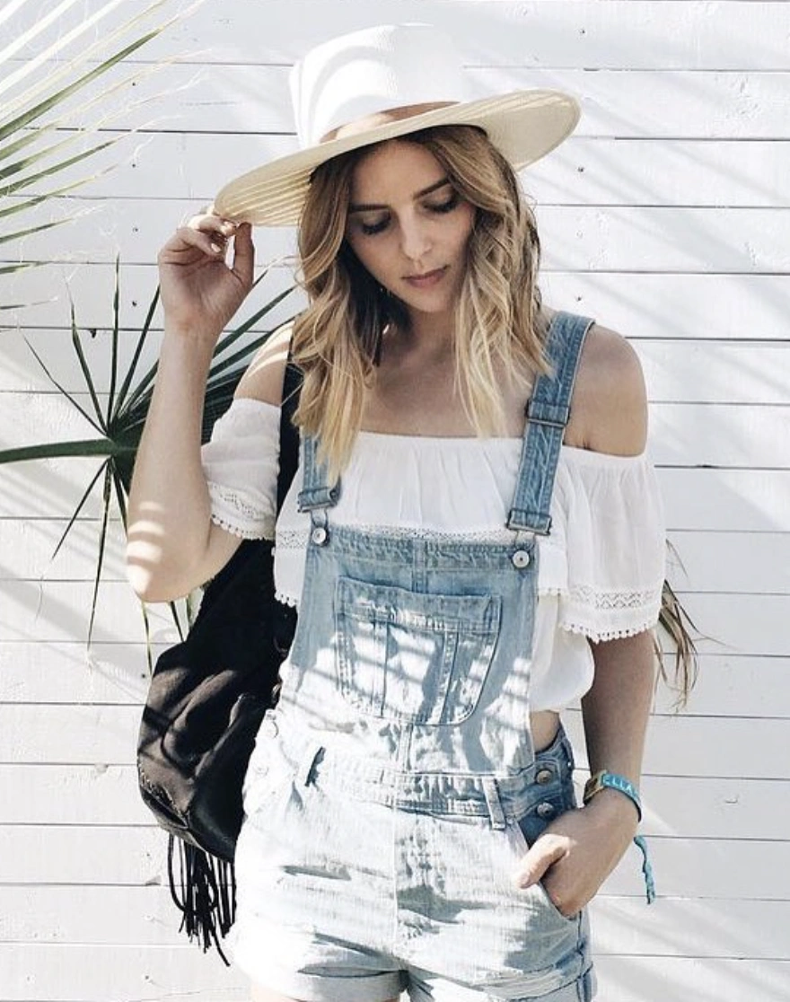 Denim Overall Shorts + White Off-Shoulder Top + Wide-Brim Hat