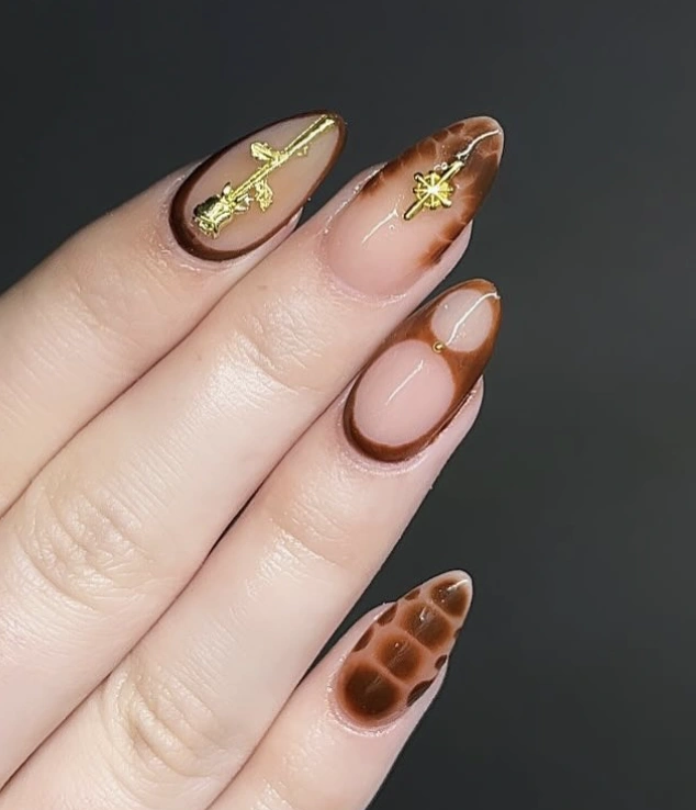 Elegant Ombre Almond Nails with Rich Brown Tones and Delicate Gold Leaf Accents