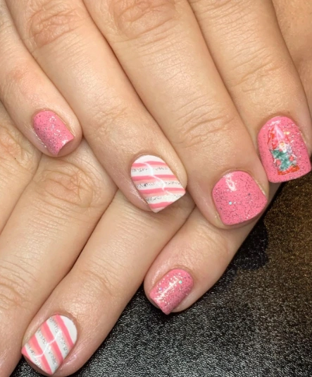 Festive Pink Christmas Nails with Striped and Gnome Accents