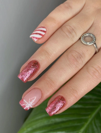 Festive Pink Glitter Nails with Candy Cane and Snowflake Accents