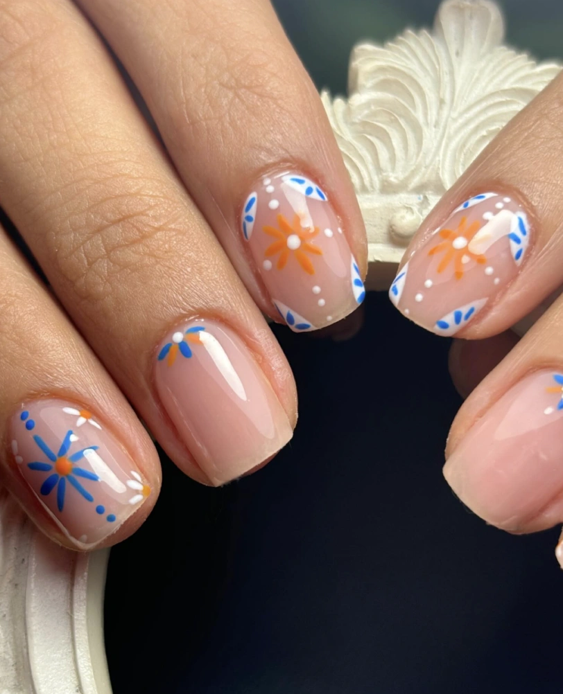 Floral Burst on Nude Nails with White Dot Accents