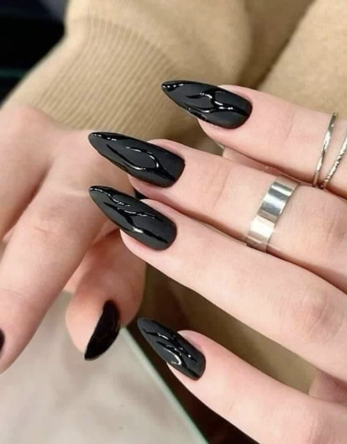 Glossy Black Stiletto Nails with Raised Design