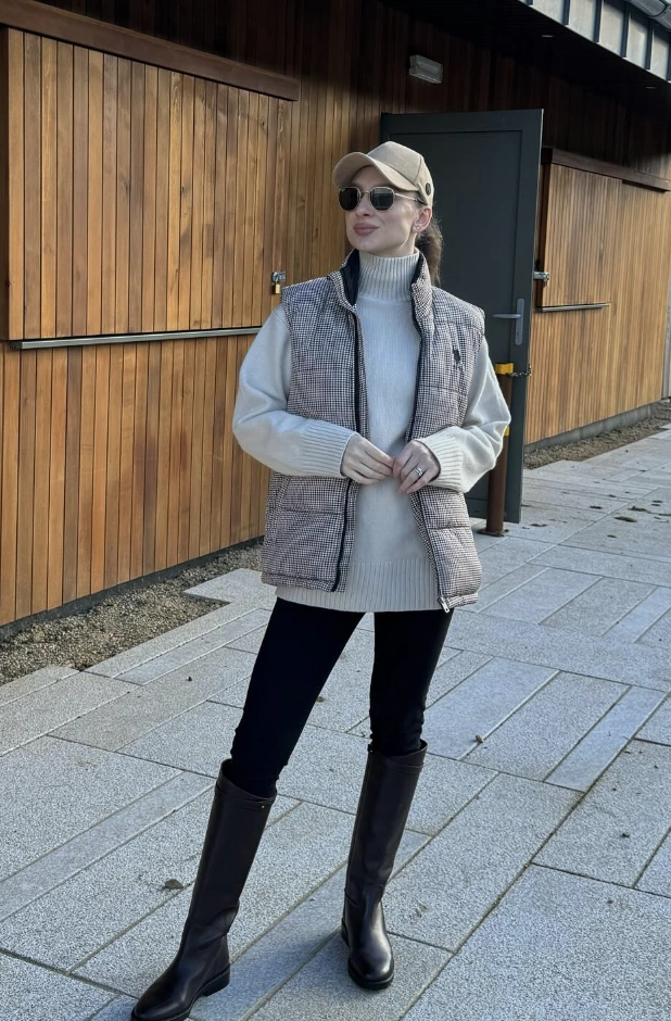Gray Houndstooth Vest + Light Gray Turtleneck Sweater + Black Skinny Pants + Black Knee-High Boots + Beige Baseball Cap