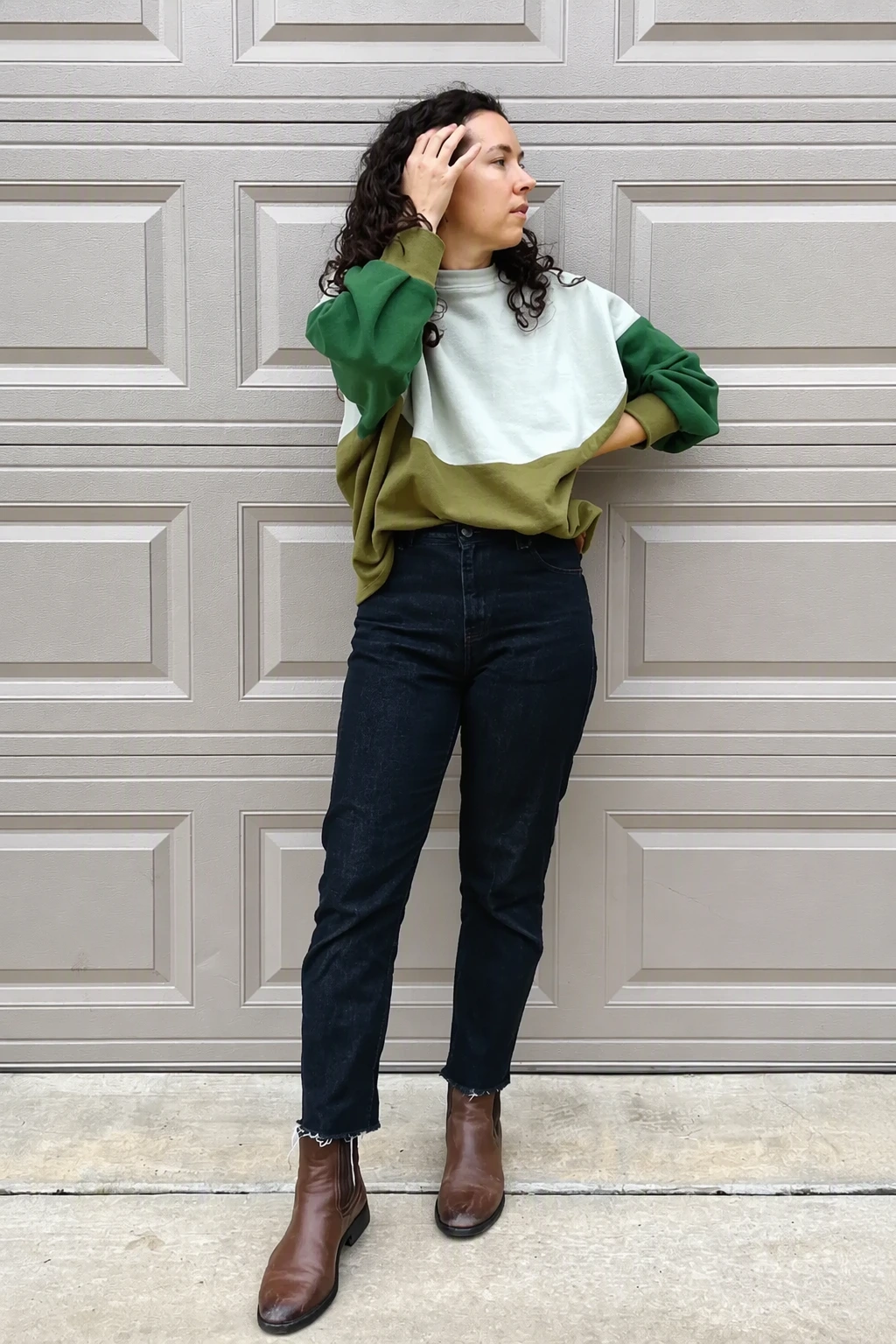 Green Colorblock Sweater + Dark High-Waisted Jeans + Brown Leather Ankle Boots