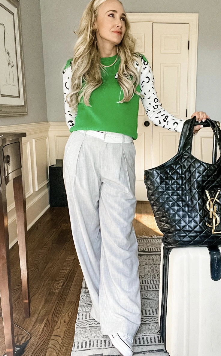 Green Sweater + White Animal Print Long Sleeve Shirt + Gray High-Waisted Trousers + Black Quilted Tote Bag + White Sneakers