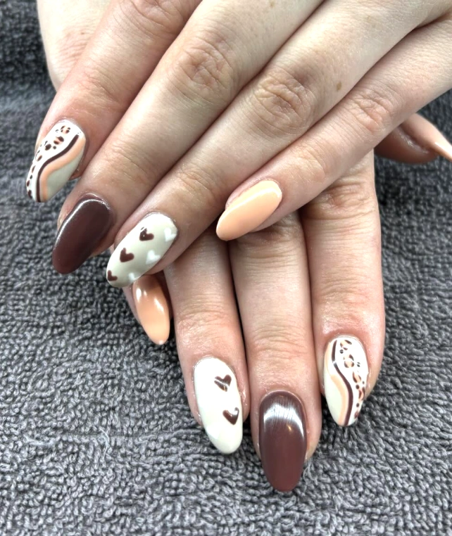 Heart-Embellished Coffin Nails in Warm Earthy Tones with Swirling Designs