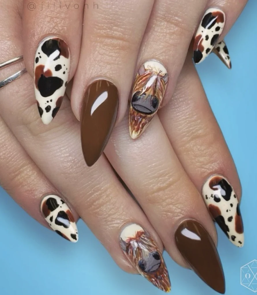 Highland Cow Themed Stiletto Nails with Solid Brown and Cow Print Accents