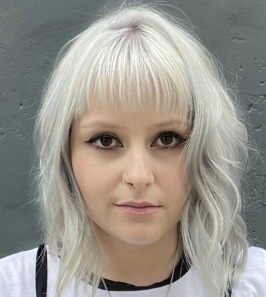 Layered Bob with Blunt Bangs and Icy Platinum Hue