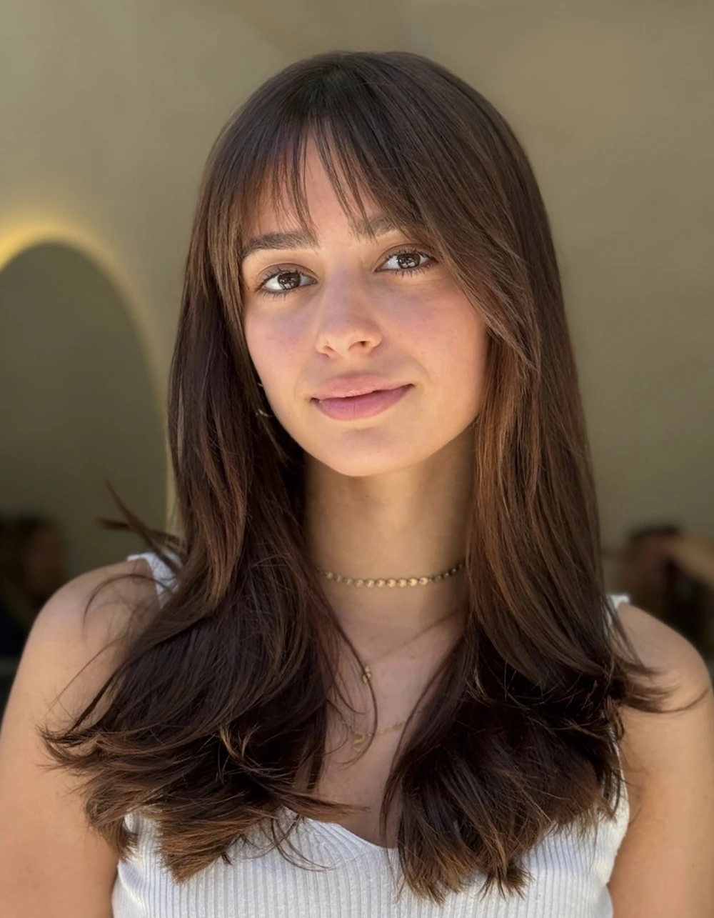 Layered Medium Hair with Curtain Bangs and Soft Face-Framing Ends