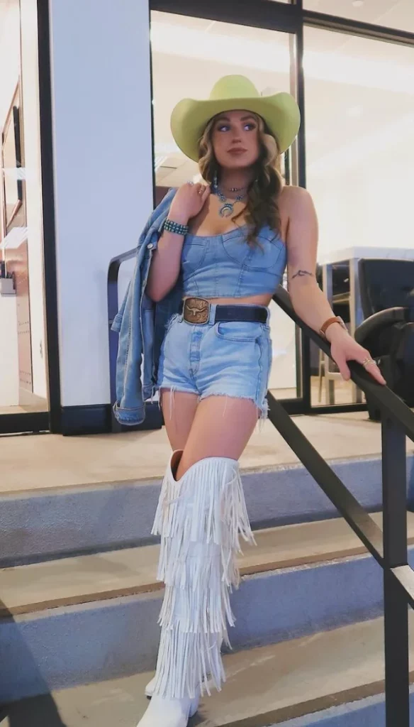 Light Blue Denim Crop Top + Light Blue Denim Shorts + White Fringe Knee-High Boots + Lime Cowboy Hat + Blue Denim Jacket