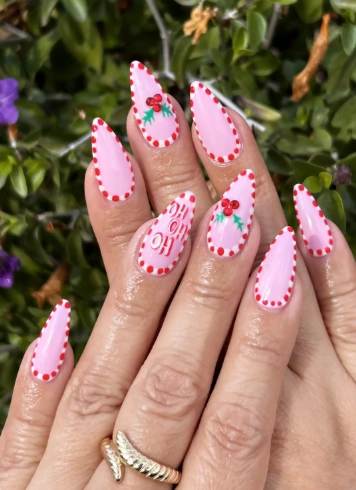 Light Pink Almond Nails with Candy Cane Border and Holiday Accents