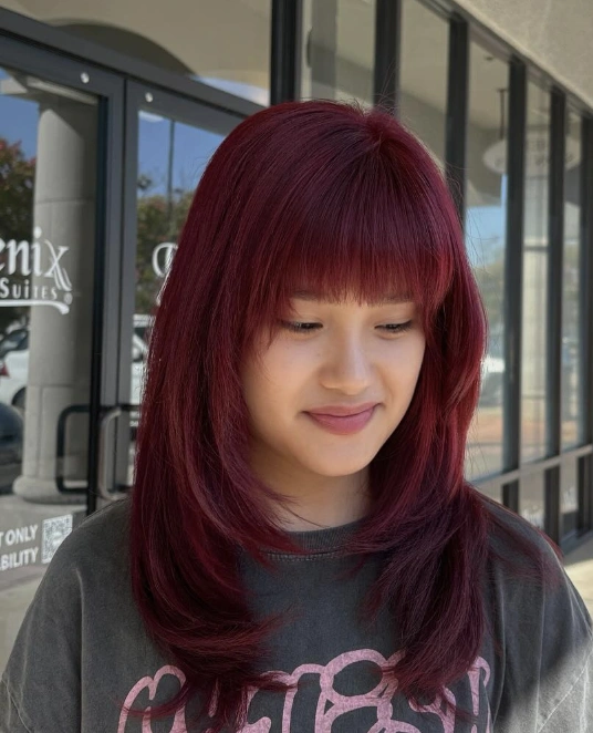Long Layered Hairstyle with Bold Burgundy Fall Hair Color for Brunettes