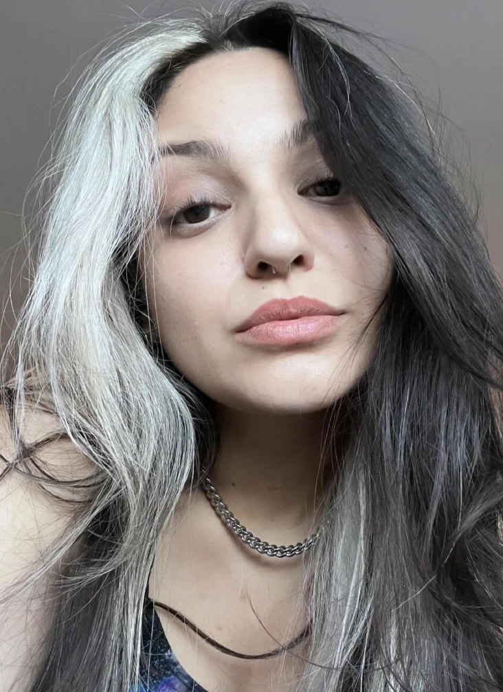 Long Wavy Hairstyle With Platinum Highlights and Dark Roots