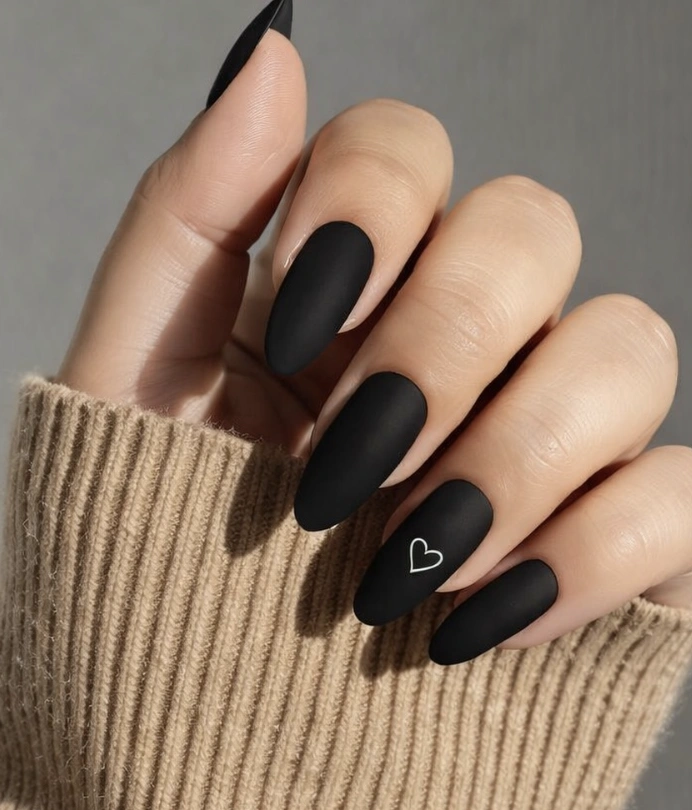 Matte Black Almond Nails with Single White Heart Accent