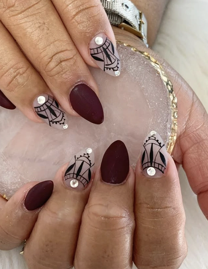 Matte Burgundy Almond Nails with Tribal Art Accents