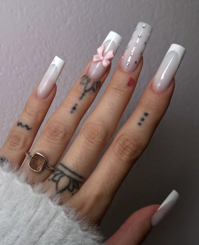 Milky French Nails with Glossy Finish and Playful Pink Accents