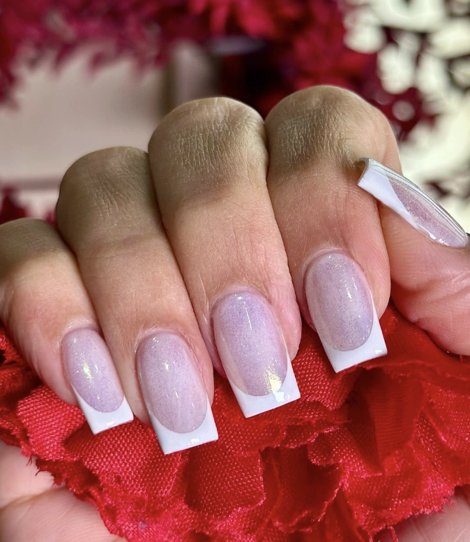 Milky White Almond Nails with Iridescent Tips and Subtle Glitter Accents