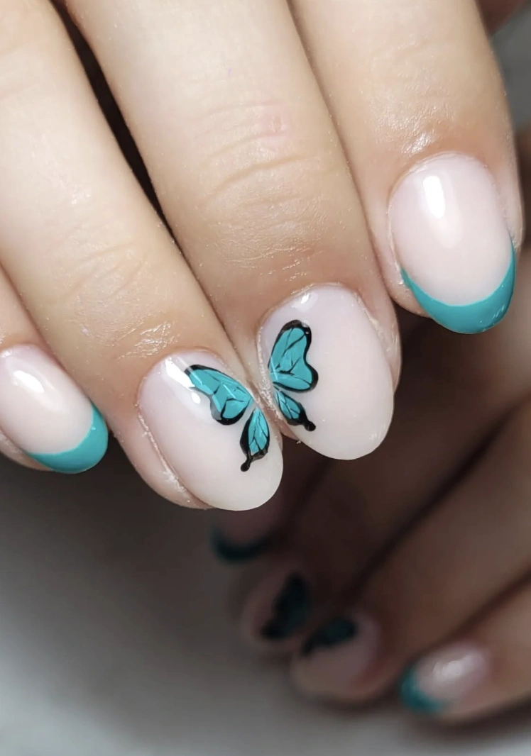 Minimalist Nude Nails with Turquoise French Tips and Butterfly Accent