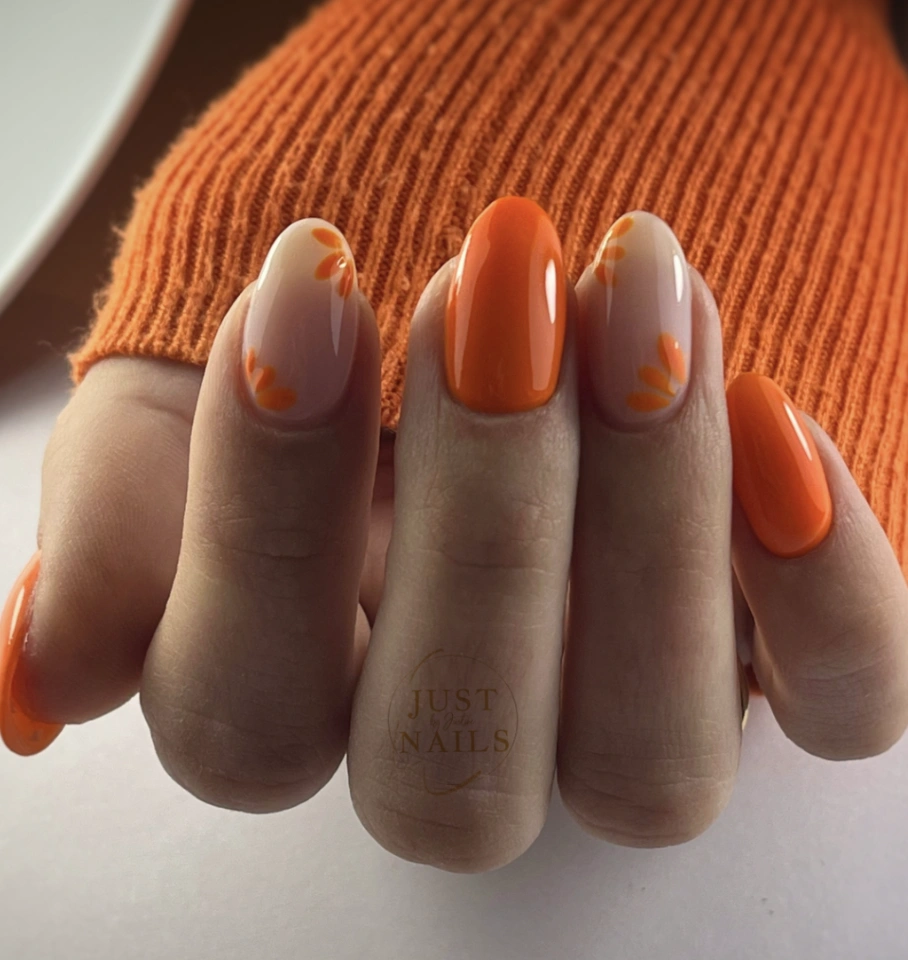 Mismatched Oval Nails: Solid Orange and Floral Accent
