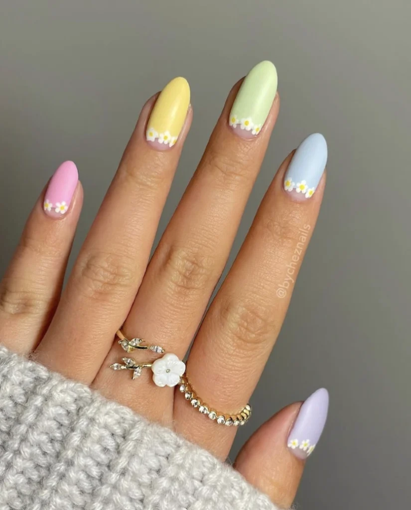 Mismatched Pastel Almond Nails with Delicate Daisy Accents