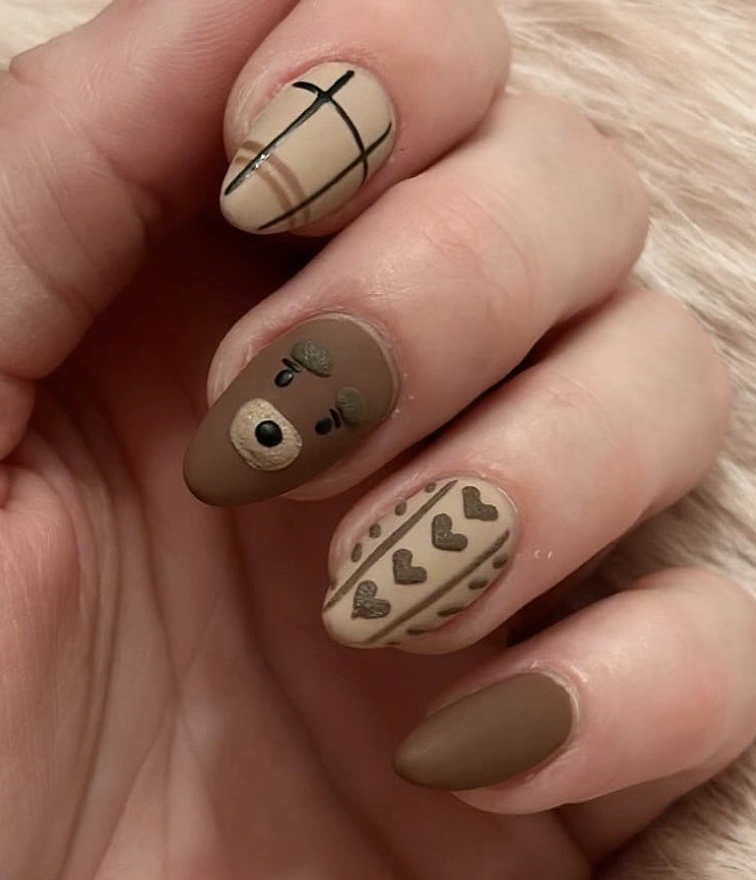 Nails in matte brown and beige, featuring a cute bear design, heart patterns, and grid lines